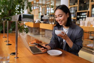 Young,Asian,Business,Woman,Wearing,Suit,Drinking,Coffee,Using,Smartphone