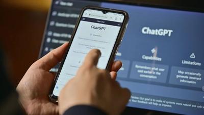 A person using their phone to interact with ChatGPT