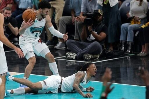 Memphis guard Ja Morant screams in pain after falling onto the court and suffering a bruised left hip in the second quarter of the Grizzlies' NBA playoff game against Oklahoma City