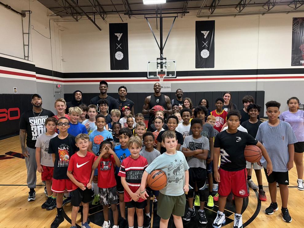 Pro basketball players practice, visit kids at local gym