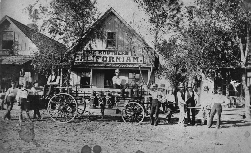 Alert Hook and Ladder Company with fire ladder wagon in fron