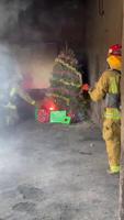 Bakersfield city firefighters demonstrate a Christmas tree fire