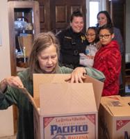 PHOTO GALLERY: Officers, deputies transform into bearers of holiday cheer with food baskets