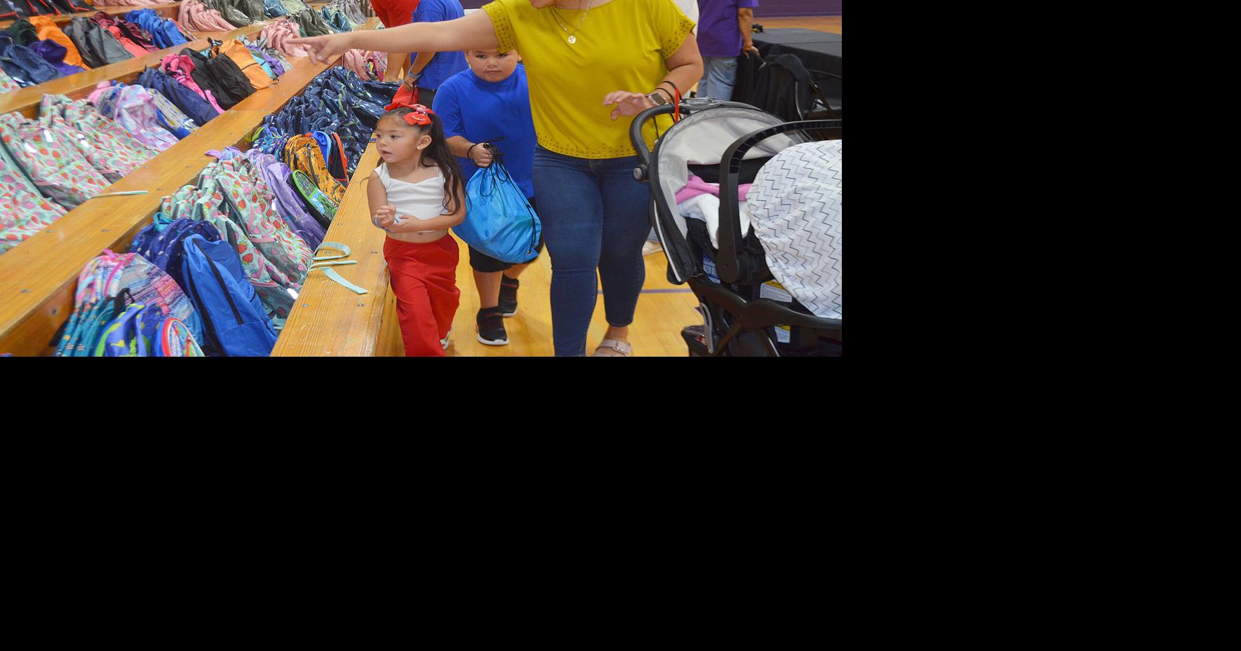 Hair cuts, back packs, bounce houses all part of Back to School event