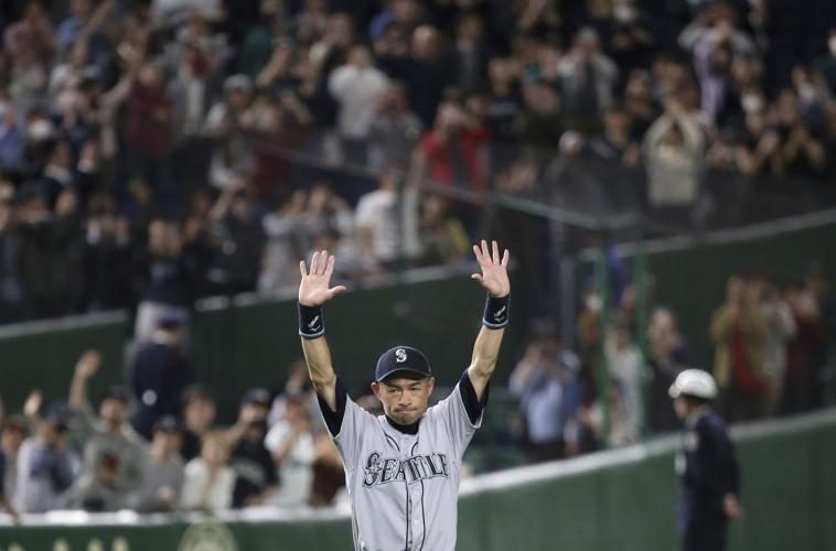 Seattle Mariners' Omar Narvaez (22) is greeted by manager Scott