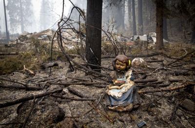 A statue of a girl reading sits in September near where the library in Blue River stood before it was destroyed in the Holiday Farm Fire.