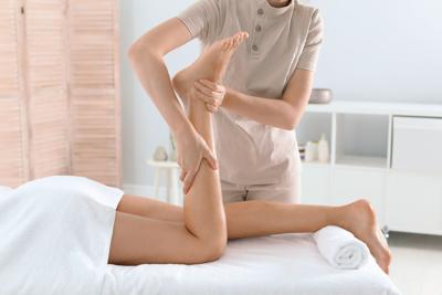 Woman receiving leg massage in wellness center