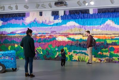Justin Favela family standing Infront of his Lanscape background.