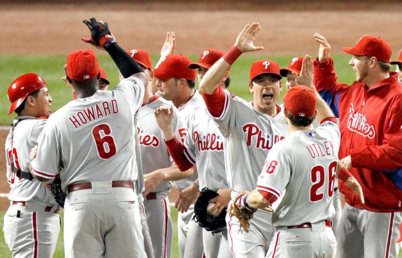 Philadelphia Phillies' Roy Oswalt, left, is greeted by teammate