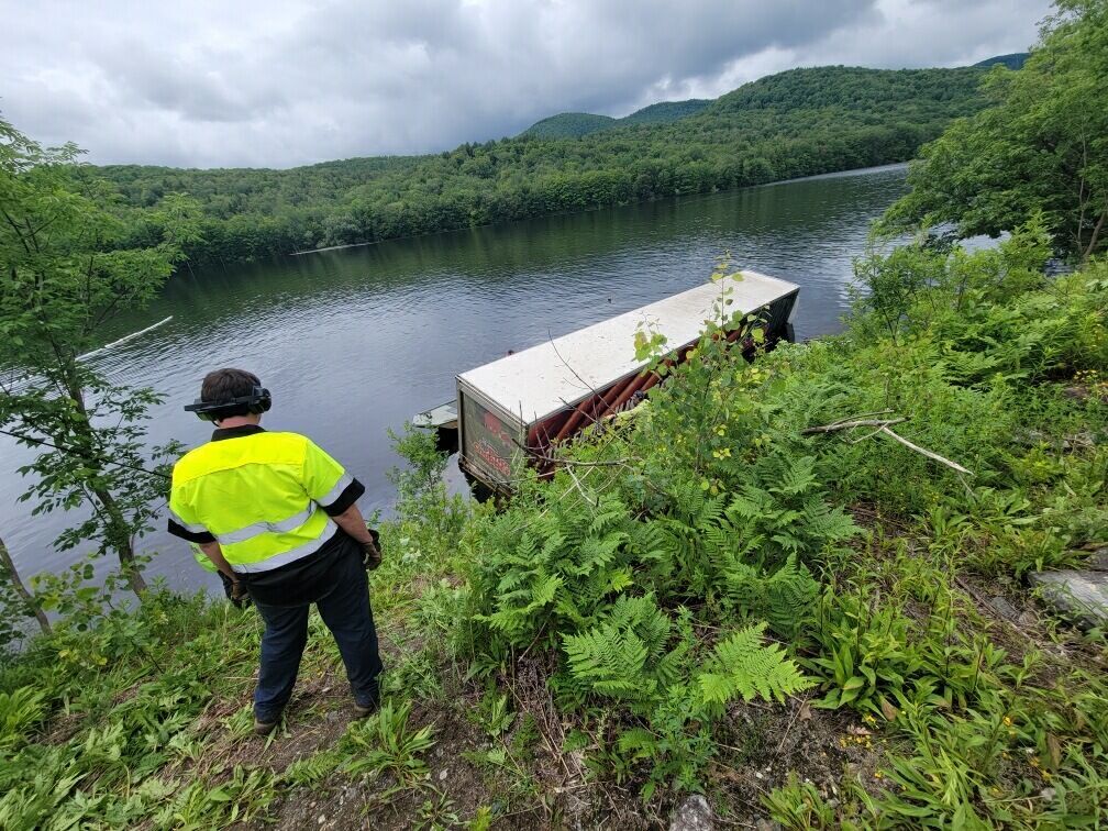 Injury hazmat cleanup after truck crashes into Harriman Reservoir