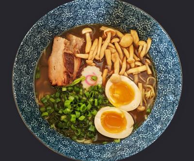 Bowl of raman with eggs, mushrooms, pork belly and scallions