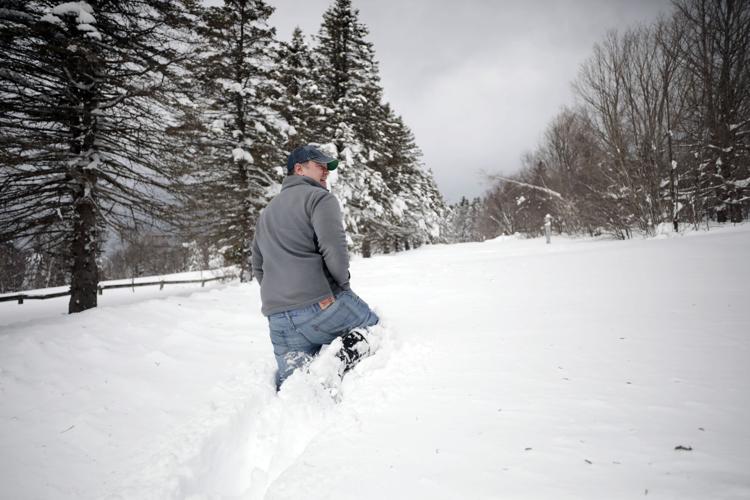 Rich Lampron walks through deep snow