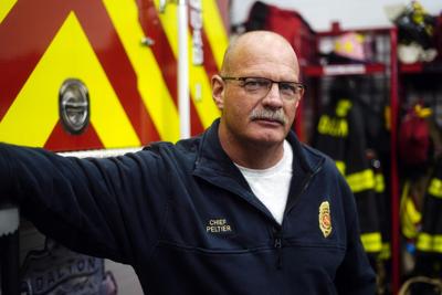 Dalton Fire Chief James Peltier stands next to a fire truck