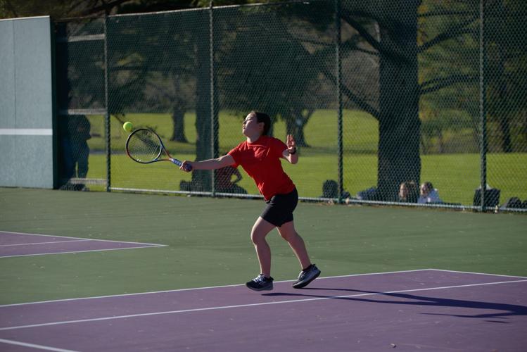 boy plays tennis