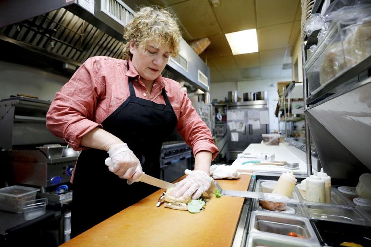 chef makes sandwich in commercial kitchen