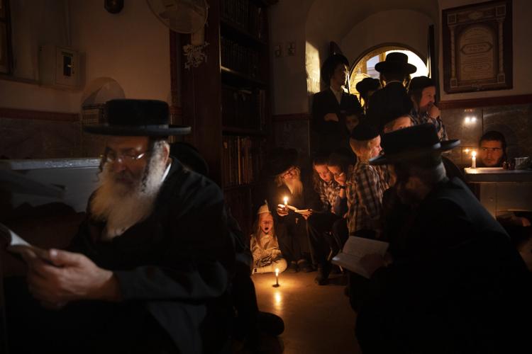 People read by candlelight