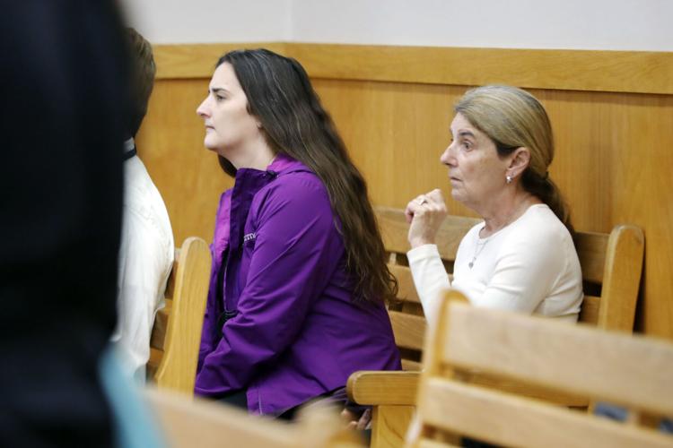 two women sit in courtroom