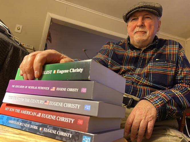 Eugene Christy with stack of books