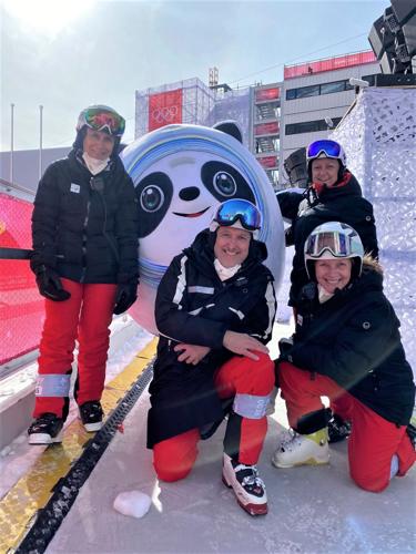 Laura Sullivan and others pose at the winter olympics