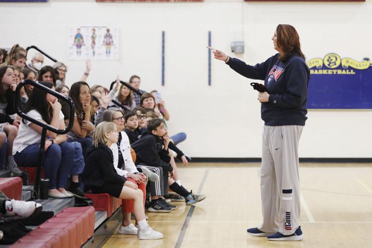 Kara Wolters speaks to students in gym