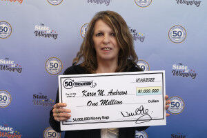 Woman holds a large check