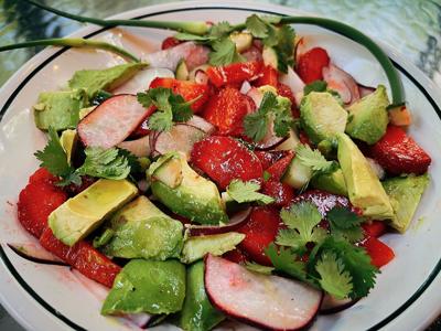 A salad made with strawberries and radishes