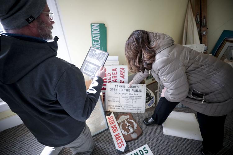 Jim McGrath and Linda Tyer look through old parks signs