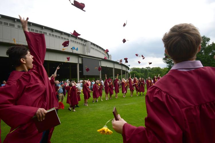 Graduates throw their caps in the air