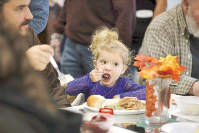 Girl enjoys eating Thanksgiving meal