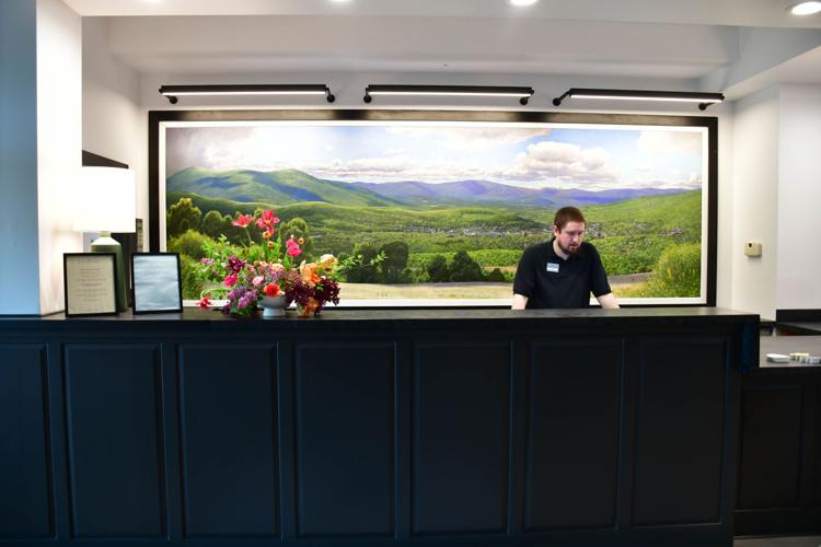 A large painting hangs behind the check-in desk