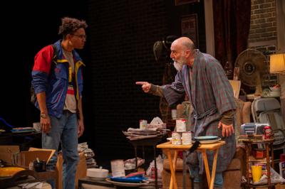 Old man in a robe points finger at teenager