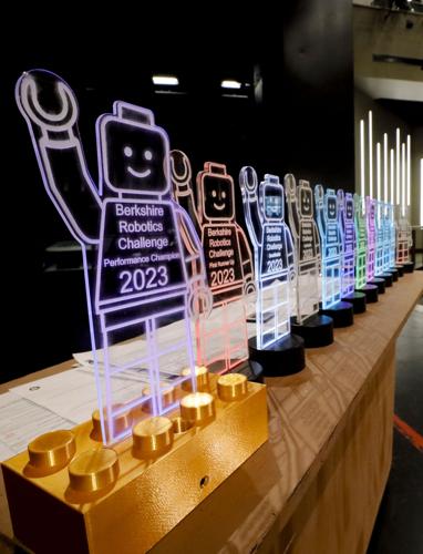 clear Lego character trophies lit with colored lights