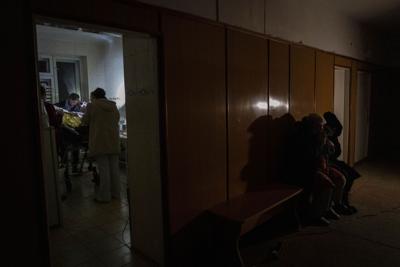 A family in a darkened hospital corridor
