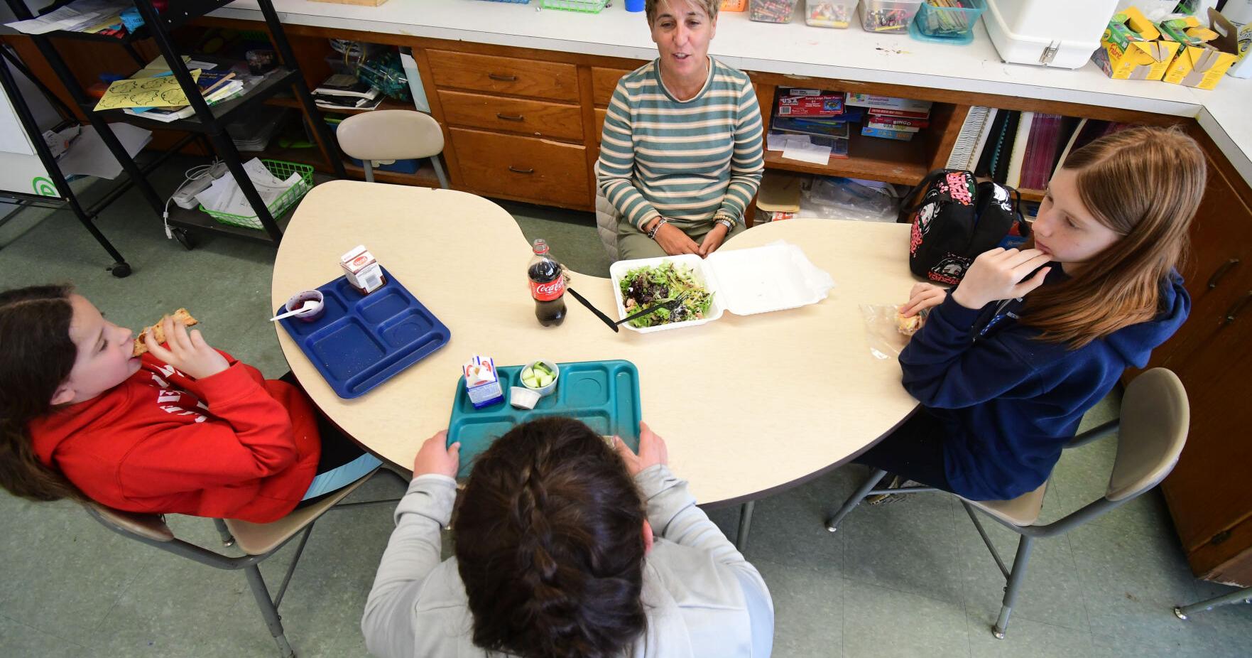 A teacher has lunch with three students