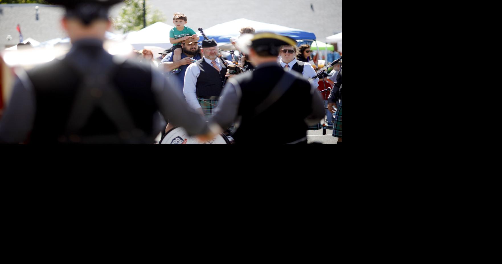 boy on man's shoulders watching fife and drum corps