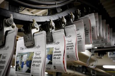 Individual newspapers travel on a track during publishing