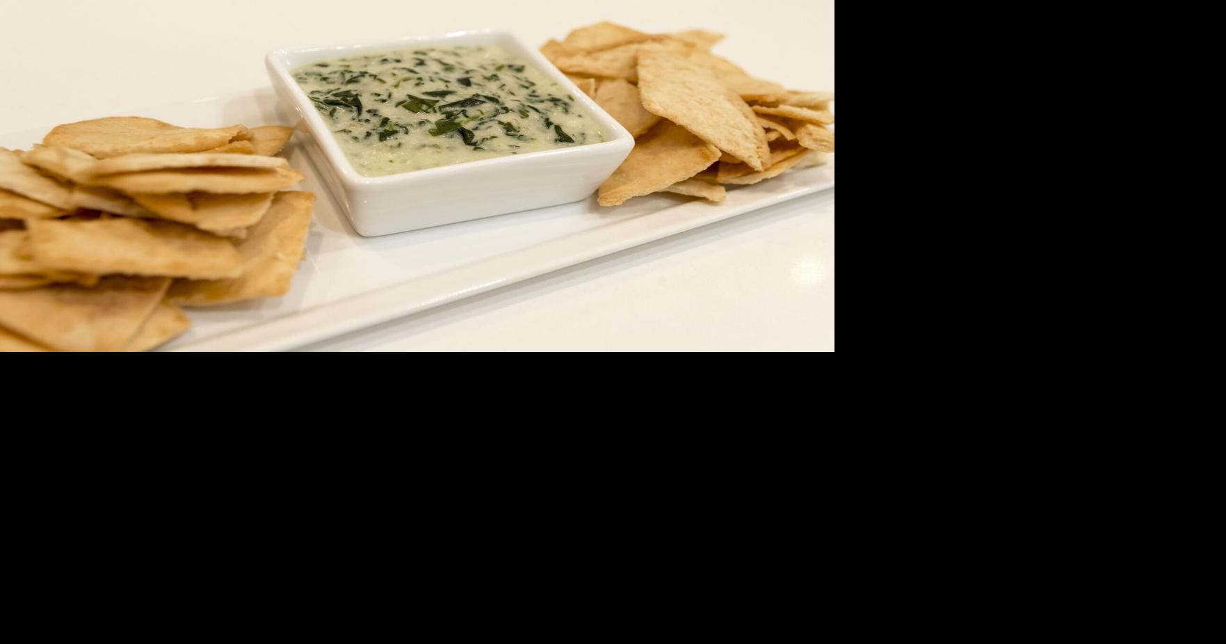 Holiday guests coming over? Whip up some spinach and artichoke dip to serve with a festive green Grinch cocktail