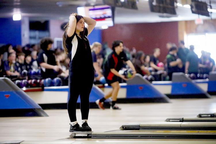 Lauren Scheurer with hand on head at bowling alley