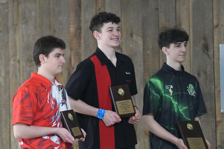 Teen boys pose with their plaques