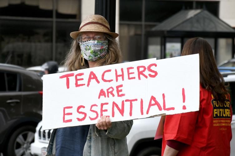 Person holding sign in support of teachers