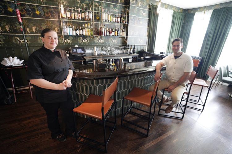 Chef Tiffani Flowers and co-owner Bryan Binder sit at the bar