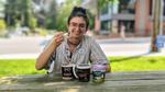 Woman eating local ice cream at a picnic table