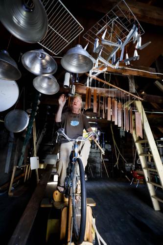 man rides mounted bike with instruments hanging around
