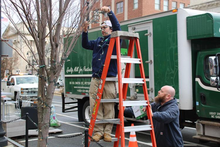 Donald Tanner strings a tree on North Street with Bill DeMarco