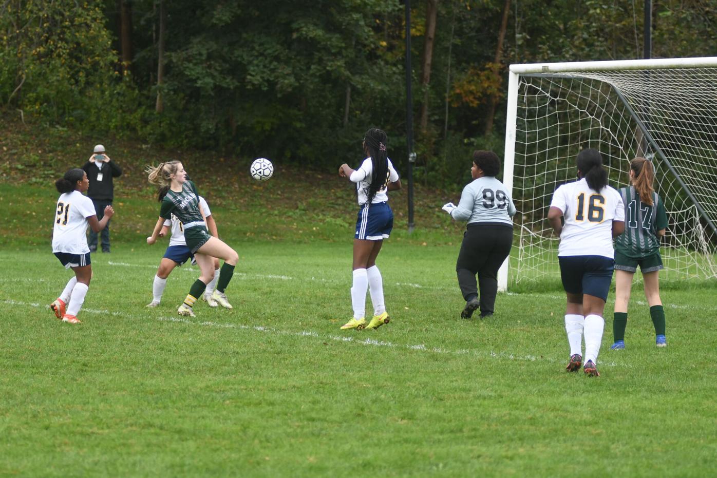 Izzy LaCasse kicks the ball at the net for a goal