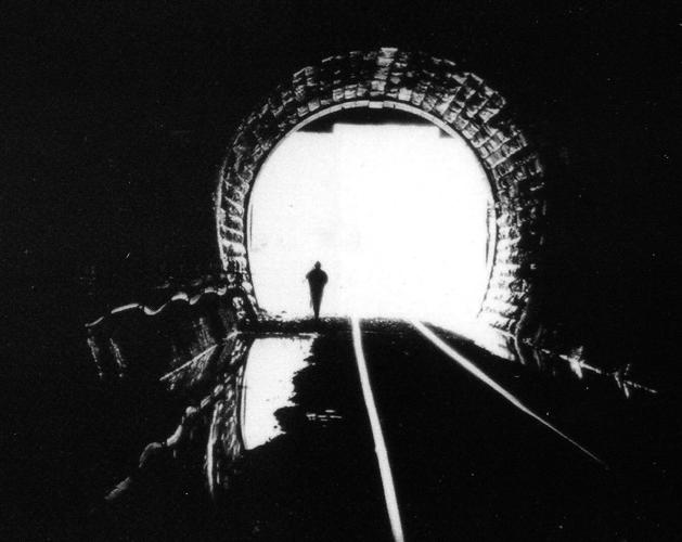 Person stands in entrance to Hoosac Tunnel