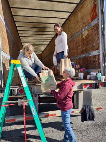 Volunteers load groceries for "Stuff the Truck" food drive in Lee