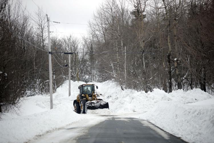 tractor clears snow from road in windsor