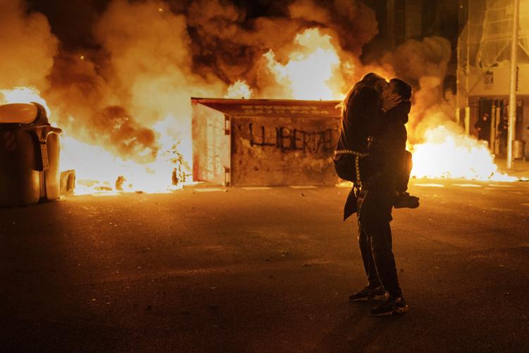 A couple embraces amid a demonstration in Spain
