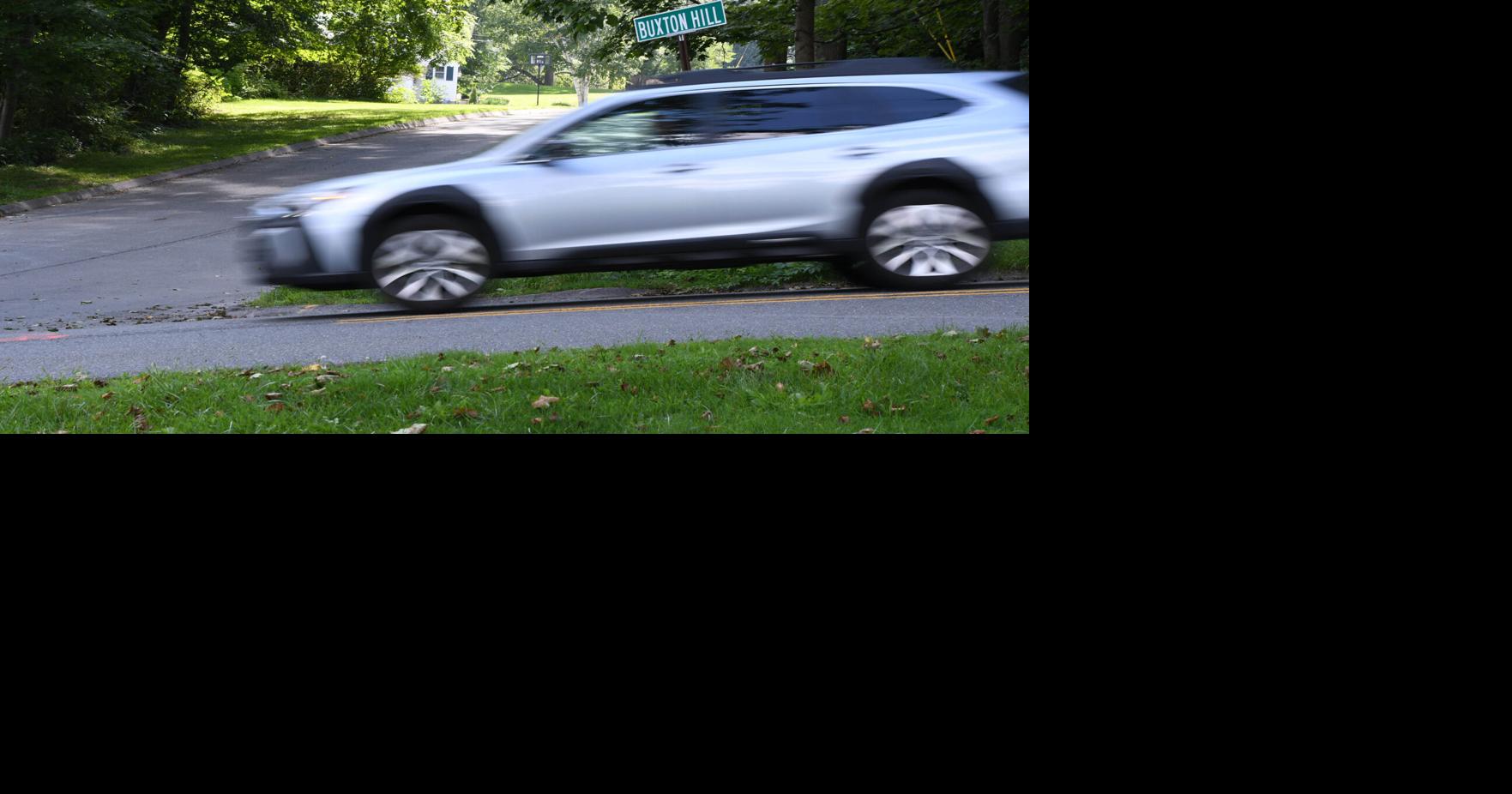A car drives down a street